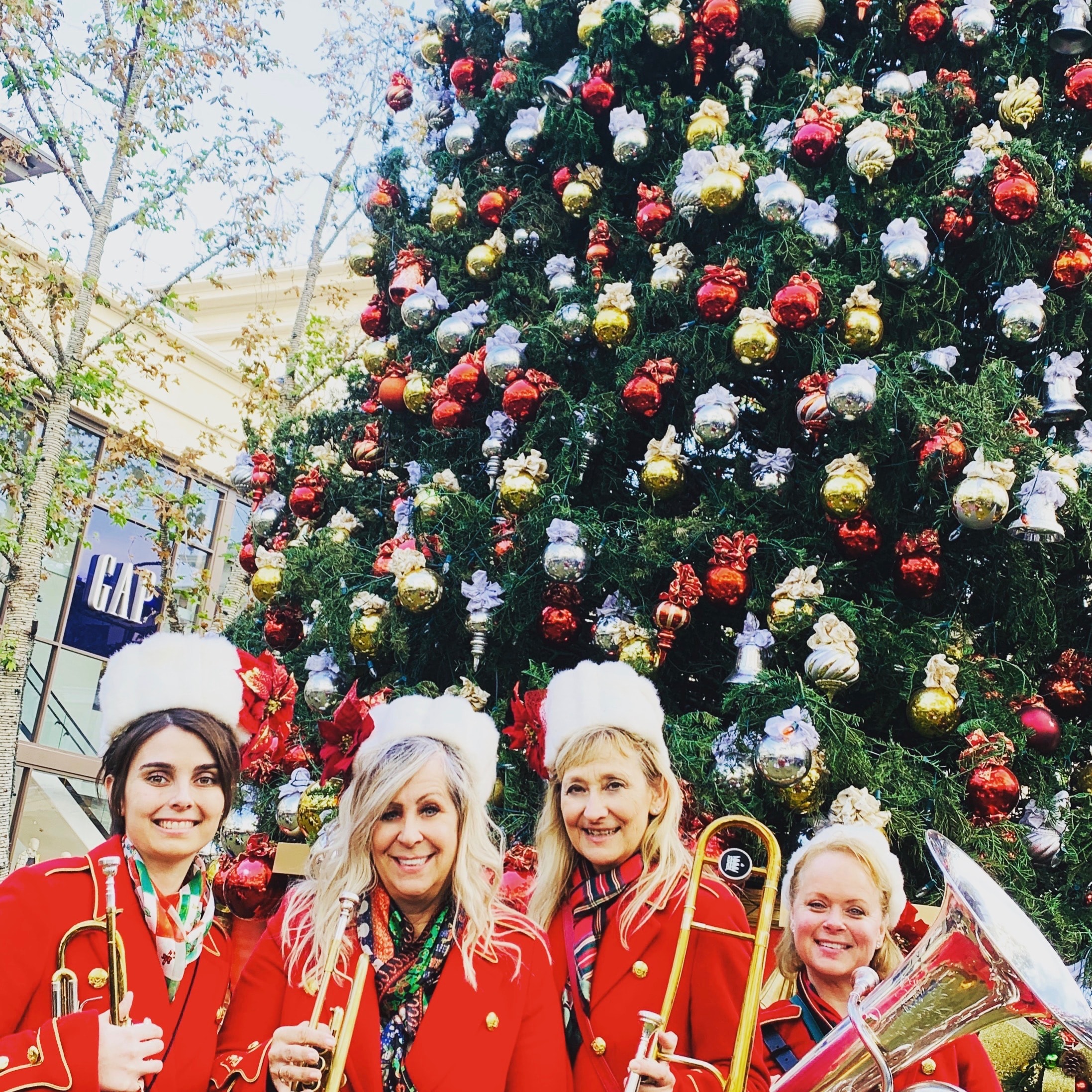 Belle Air Brass posing at festive ornament wall